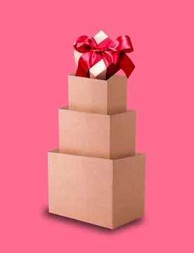 Cardboard boxes in the shape of a Christmas tree on pink background. Stock Photos