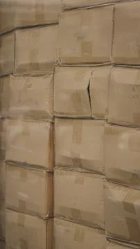 Cardboard boxes stacked inside distribution warehouse close up Stock Photos