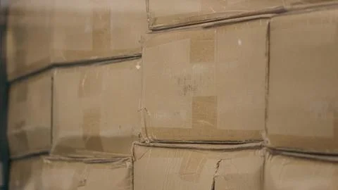 Cardboard boxes stacked inside distribution warehouse close up Stock Photos
