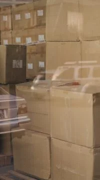 Cardboard boxes stacked inside warehouse behind reflection window close up Stock Photos