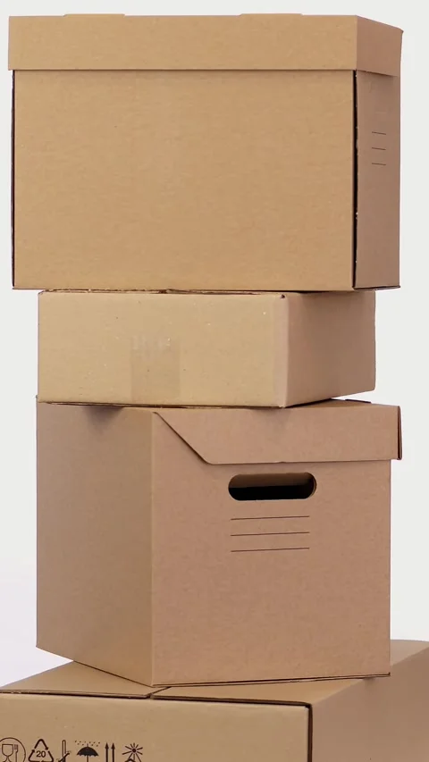 Cardboard boxes stand on top of one another, rotate on a white background. Stock Footage 321461879