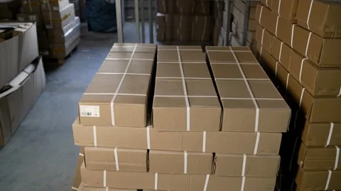 Cardboard boxes stocked in large distribution warehouse Video stock 325791913