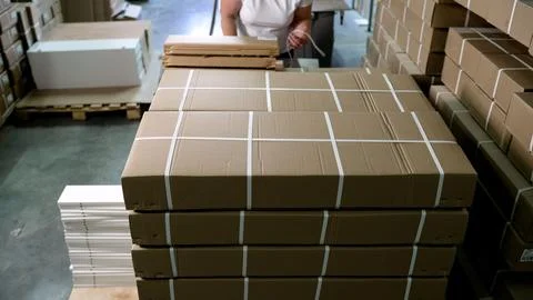 Cardboard boxes stocked in large distribution warehouse Stock Photos