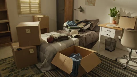 Cardboard Boxes with Suitcase in Messy Room Ready for Moving Stock Footage 338109490