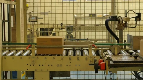 Cardboard boxes travelling along a conveyor belt in a rice factory – 4K Stock Footage