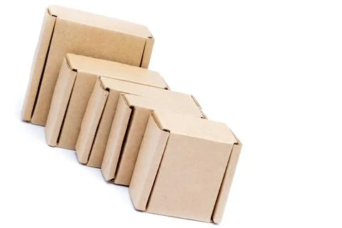 Cardboard boxes of various sizes are arranged in a row diagonally. Isolated o Stock Photos