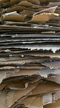 Cardboard crates stacked background. Stacking used cardboard for recycling. Full Stock Photos