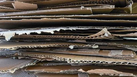 Cardboard crates stacked background. Stacking used cardboard for recycling. Full Stock Photos