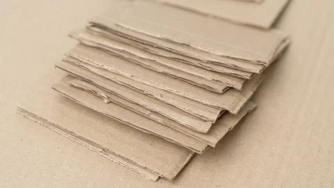 The cardboard is cut into small rectangular pieces and prepared for recycling, c Stock Photos
