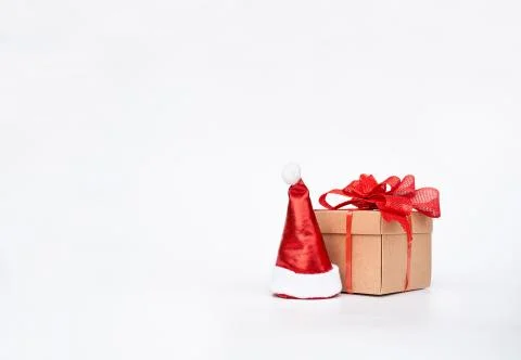 Cardboard gift box and santa hat on a white background. Stock Photos