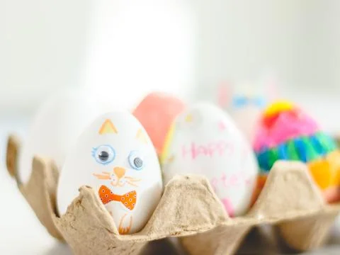 Cardboard package with decorated Easter eggs with glued and painted Easter .. Stock Photos
