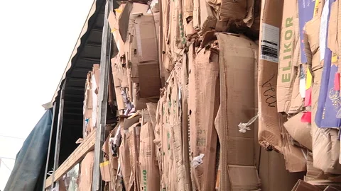 The cardboard packaging is compressed and prepared for recycling Stock Footage 104643966