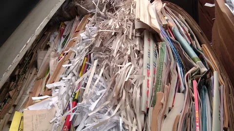 The cardboard packaging is compressed and prepared for recycling Stock Footage 104644959