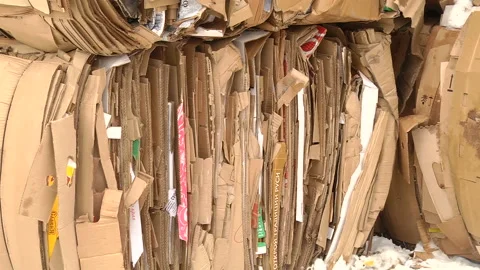 The cardboard packaging is compressed and prepared for recycling Stock Footage 104647029