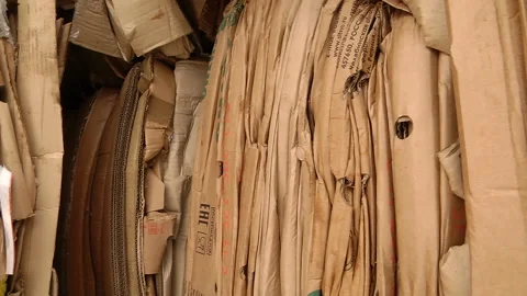 The cardboard packaging is compressed and prepared for recycling Stock Footage 104647450