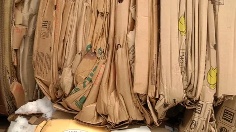 The cardboard packaging is compressed and prepared for recycling Stock Footage 104647455