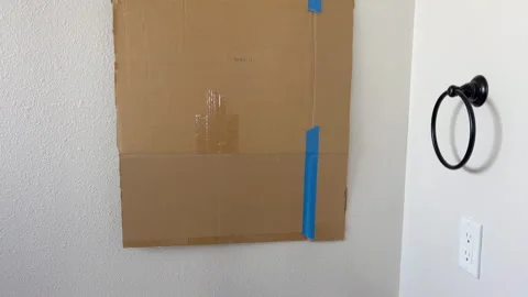 Cardboard Template Taped to Bathroom Wall Stock Footage 344933184