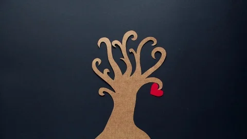 A cardboard tree on a black background with paper hearts Stock Footage 72285262
