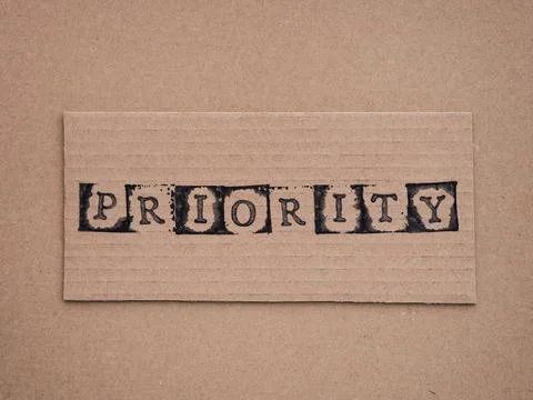 Cardboard with word Priority Stock Photos