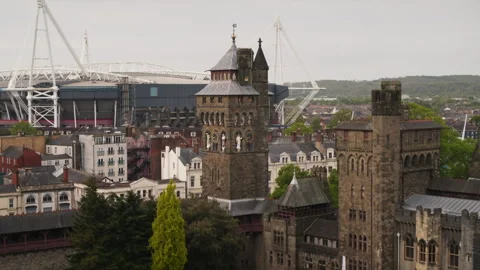 Cardiff Castle clock tower and Millennium Stadium view Stock-Footage 336809379