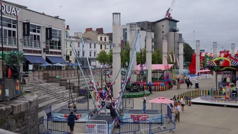 CARDIFF, UK - AUGUST 8, 2025 - Bungee trampoline and other attractions Stock Footage 314802420