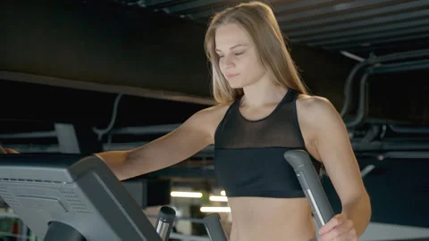 Cardio trainer if young active woman in gym. Stock Footage 109407085