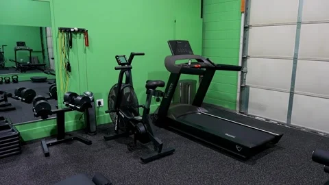 Cardio training equipment setup with treadmill and air bike in physiotherapy gym Stock Footage 330584086
