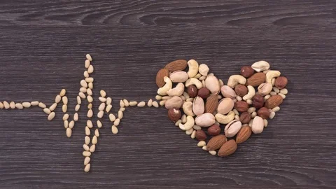 The cardiogram and heart made of nuts. Stop motion Video stock 72708646