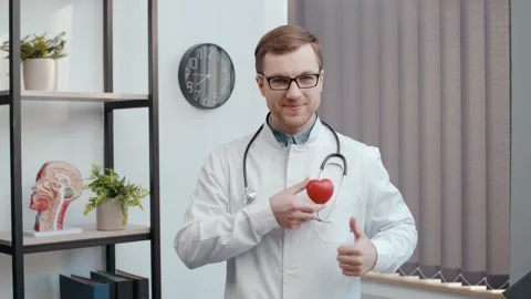 Cardiologist doctor with a toy red heart. Stethoscope and cardiogram Stock-Footage 233832853