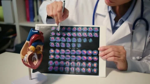 Cardiologist sitting at the table and explain the disease in hospital Stock Footage 251941258