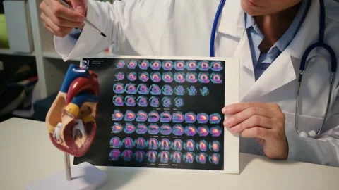 Cardiologist sitting at the table and explain the disease in hospital Stock Footage 251941278