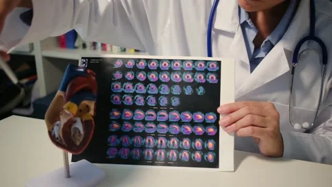 Cardiologist sitting at the table and explain the disease in hospital Stock Footage 251941281