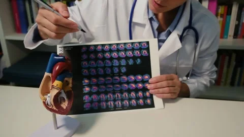 Cardiologist sitting at the table and explain the disease in hospital Stock Footage 251941288