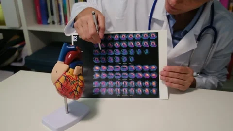 Cardiologist sitting at the table and explain the disease in hospital Stock Footage 251941312