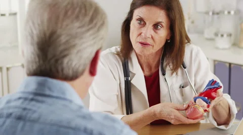 Cardiologist talking to elderly patient about his heart Stock-Footage 44978369