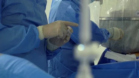 Cardiologists using cardiovascular imaging system with fluoroscopic X ray tube Stock Footage 237551643