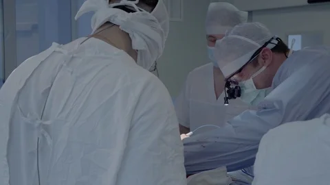 Cardiosurgeons perform a cut with the help of a coagulator. Aorto-coronary Stock Footage 104920233
