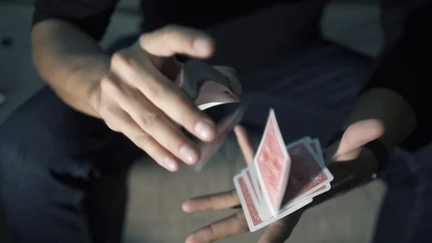 The cards fly from one hand to the other. manipulation with a deck of cards Stock Footage 89446640