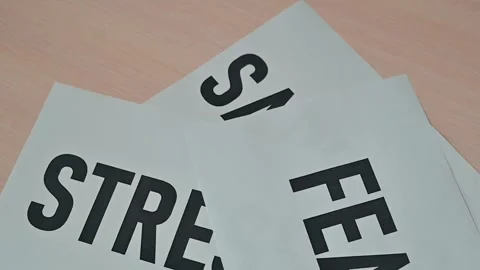 Cards with words representing various emotions are laid out on a table. The Stock-Footage 338188231