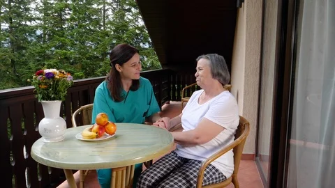Care worker spending time with old lady in her home Stock Footage 102360613