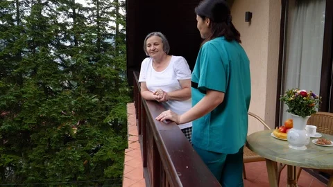 Care worker spending time with senior woman in nursing home care center Video stock 102373106
