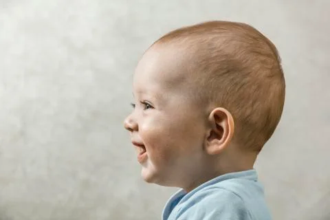 A carefree baby smiling and laughing while looking off camera Stock Photos