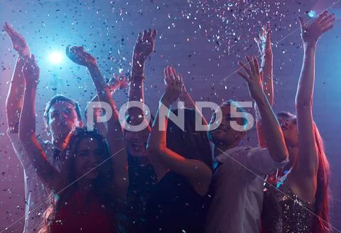 Carefree dancers enjoying disco in club Stock Photos
