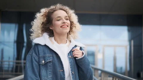 Carefree joy and fun. a young charming girl walks down the street and smiles Stock Footage 106900268
