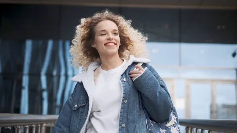 Carefree joy and fun. a young charming girl walks down the street and smiles Stock Footage 123711459