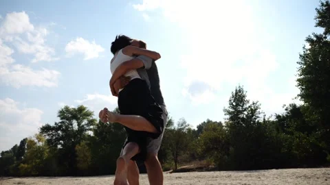 Carefree lovers having fun together on seashore at summer vacation. Man taking h Stock Footage 344041033