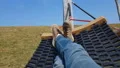 Carefree man relaxing in hammock, spring vacation outside city, tranquility HD Footage