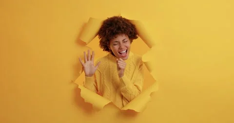 Carefree optimistic dark skinned young woman with curly hair dances happily and Stock Footage 143171630