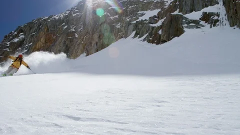 Carefree skier breaking down the snow while skiing in slow motion Stock Footage 116788974