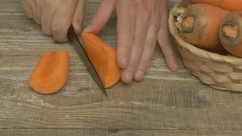 Careful and precise preparation of fresh carrots using a wellmaintained chefs Stock Footage 282581839
